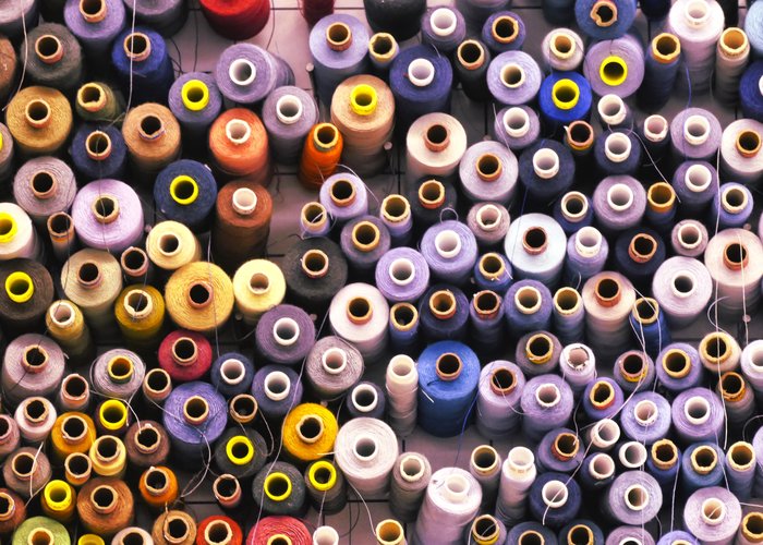 Spools of dyed yarn — raw fiber for processing